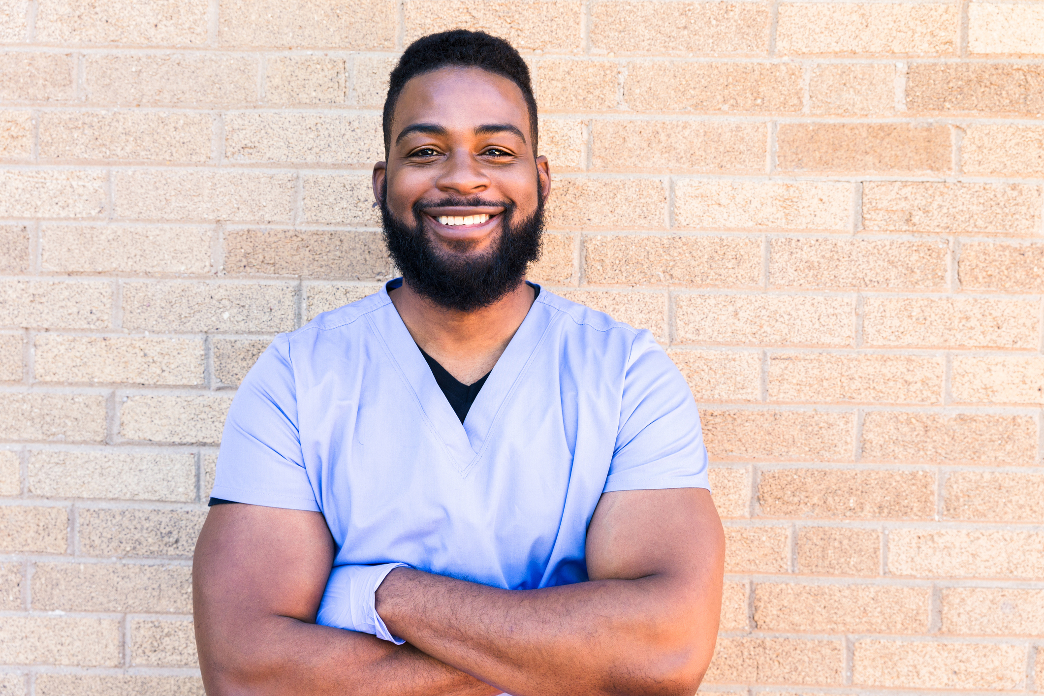 Male nurse wearing protective gloves smiles at camera Computer Keyboard With Red Cookies Key