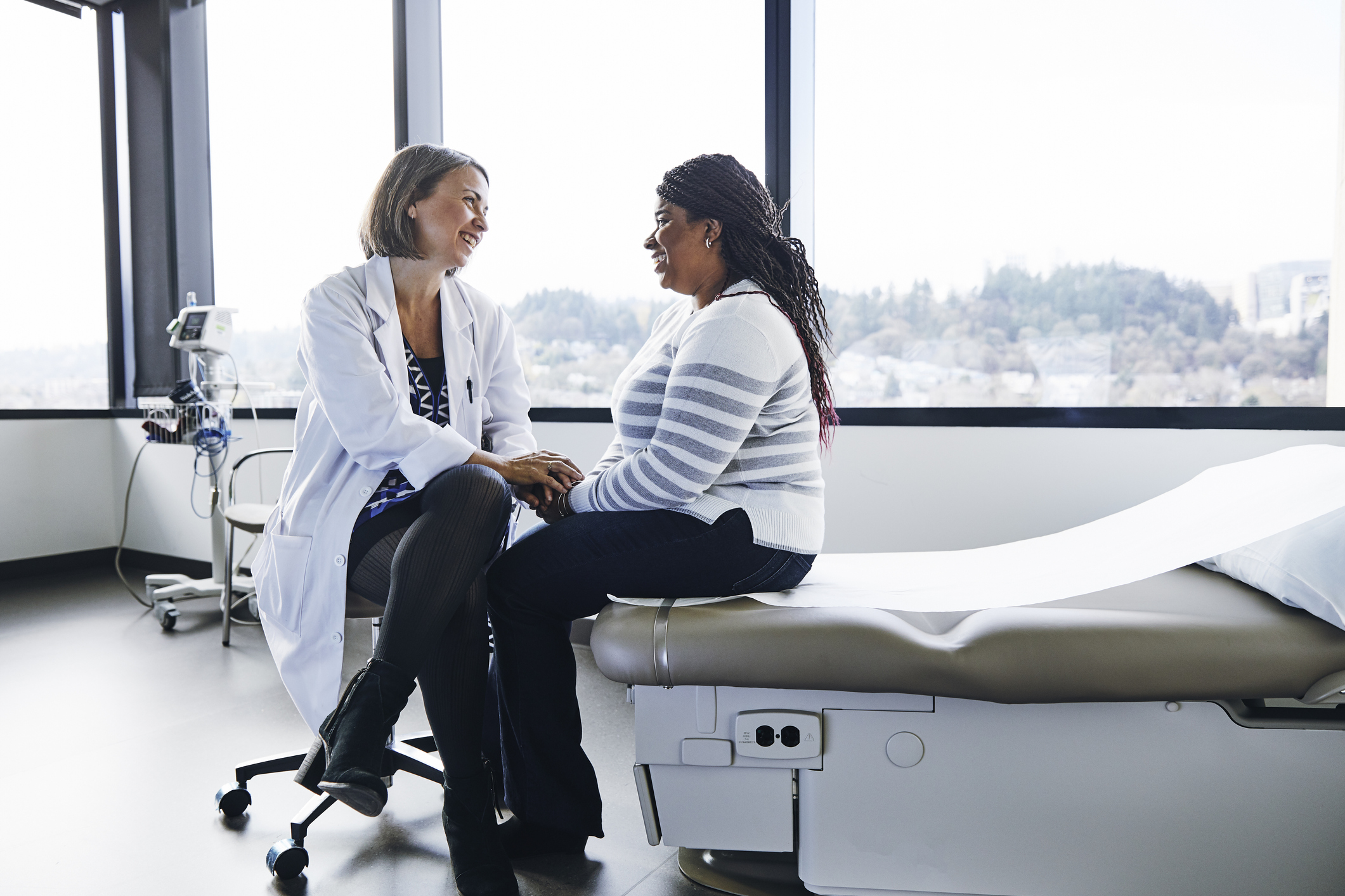 Smiling female doctor talking to woman in hospital Computer Keyboard With Red Cookies Key