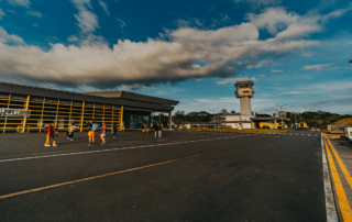 small airport runway with a handful of people outside taking pictures