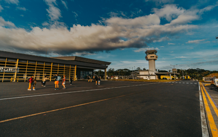 small airport runway with a handful of people outside taking pictures