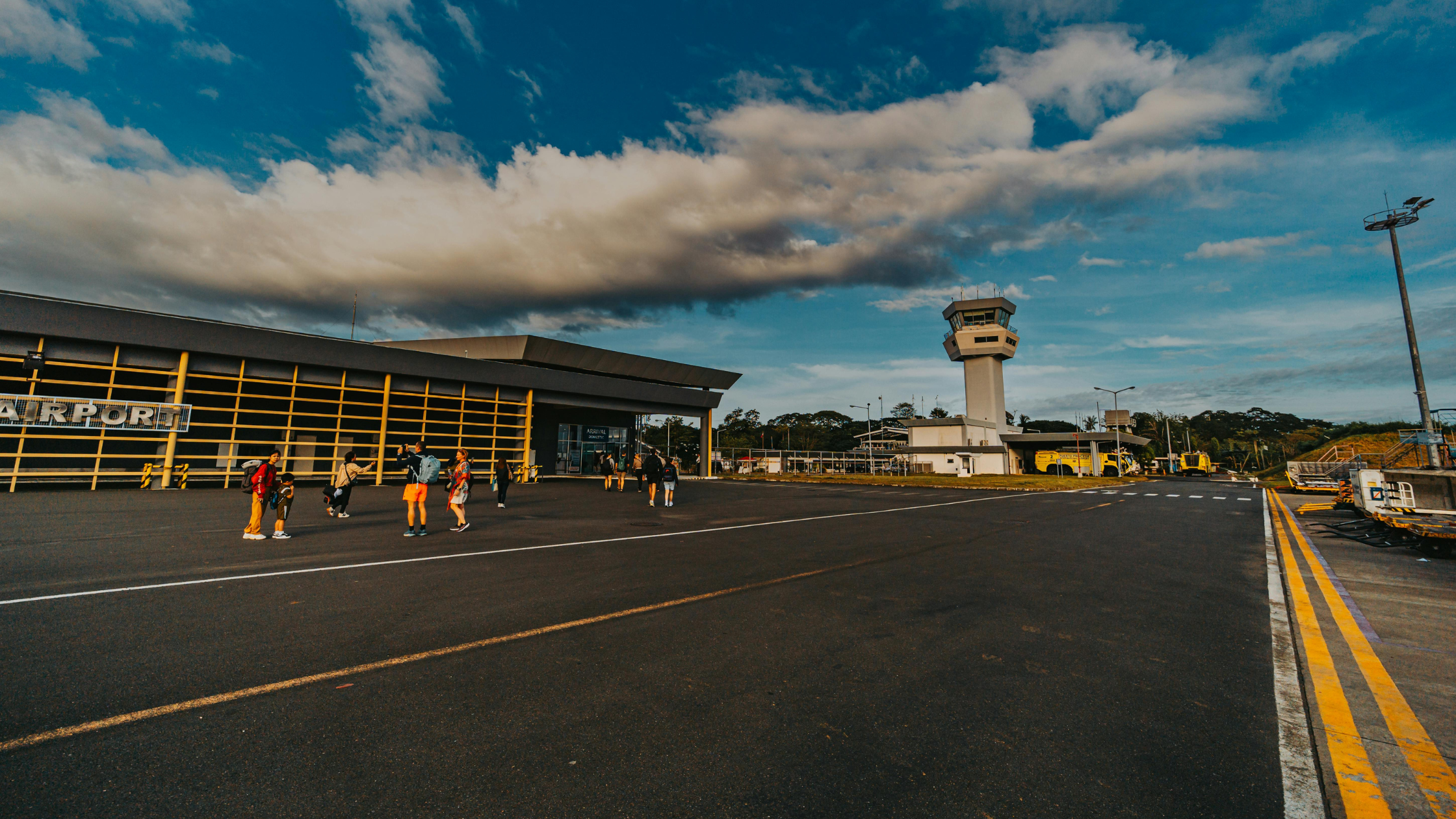 small airport runway with a handful of people outside taking pictures